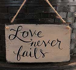 Love Never Fails Wood Sign